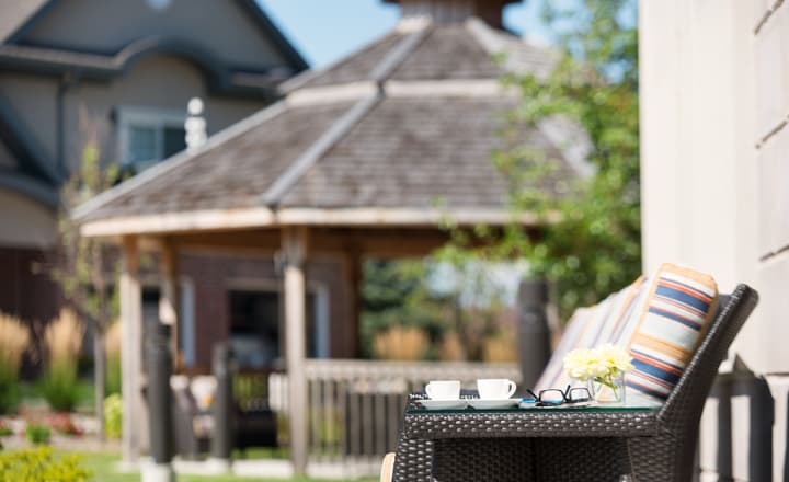 StoneyCreek-home-outdoor_area_with_lounge_chairs_and-gazebo_in_the_background Amica Stoney Creek's outdoor area with patio chairs in the foreground, and a gazebo in the background.