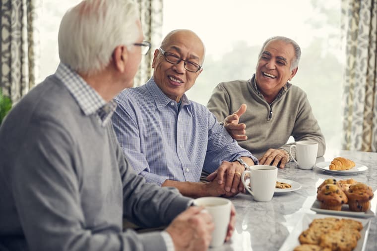 Lifestyle Shoot - Male Residents Socializing Three male residents socializing with coffee and assorted pastries at table